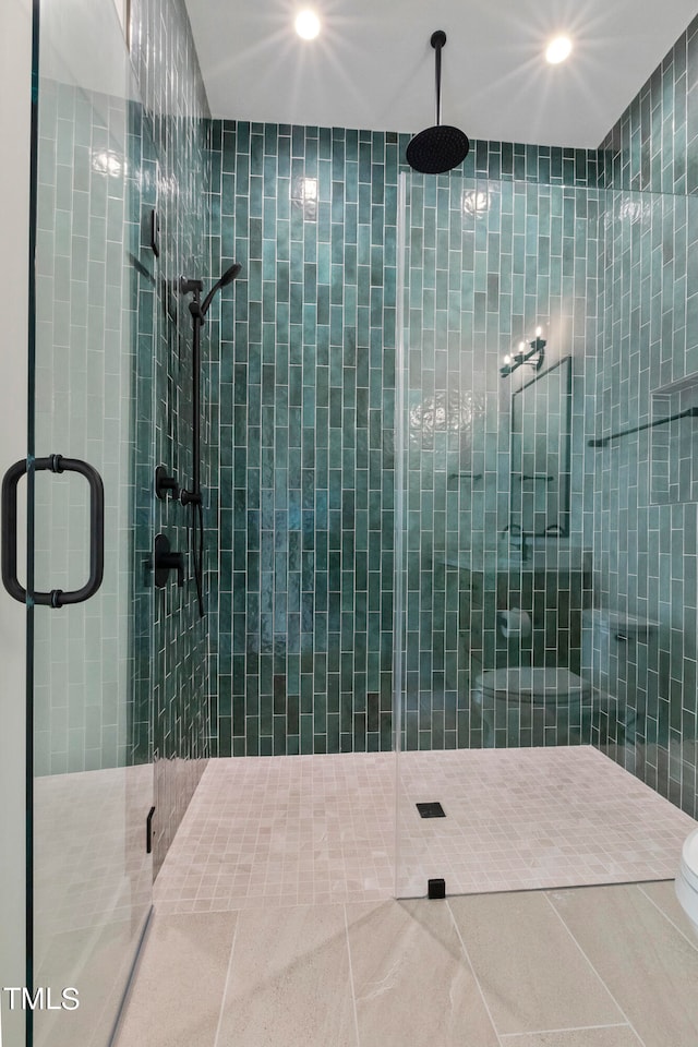 full bathroom with toilet, a stall shower, and tile patterned flooring