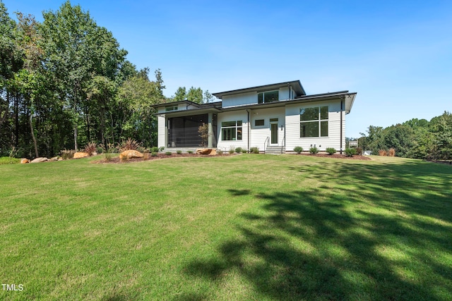 view of front facade featuring a sunroom and a front lawn