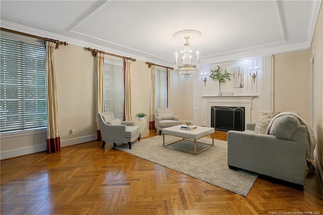 living room featuring an inviting chandelier, parquet floors, and ornamental molding