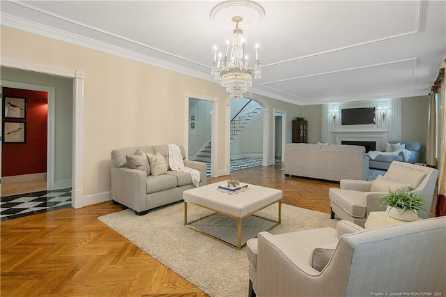 living room with light parquet flooring, ornamental molding, a notable chandelier, and ornate columns