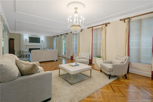 living room featuring light parquet floors, crown molding, and a chandelier