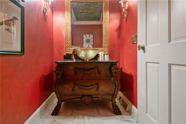 sitting room featuring tile flooring and ornamental molding