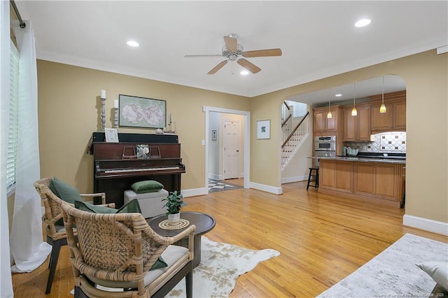 living room with ceiling fan and light wood-type flooring