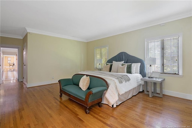 bedroom featuring crown molding and light hardwood / wood-style floors