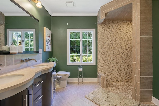 bathroom featuring toilet, vanity, ornamental molding, backsplash, and tile flooring