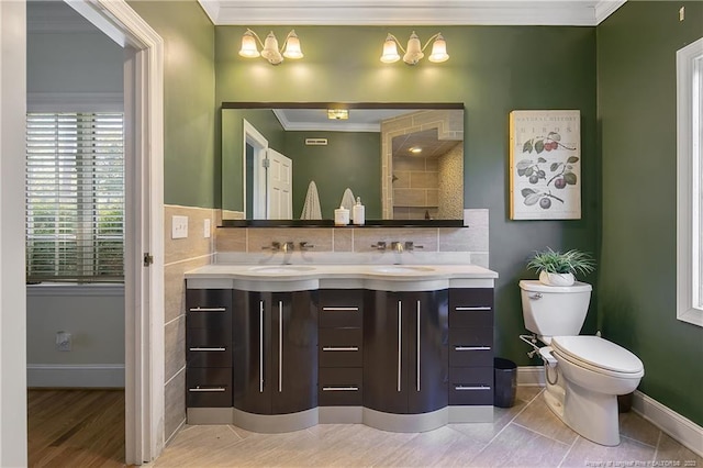 bathroom featuring tile floors, tasteful backsplash, double vanity, toilet, and crown molding