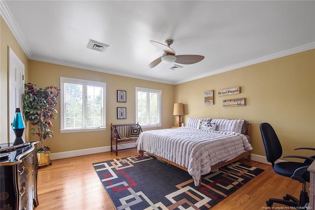 bedroom featuring ornamental molding, ceiling fan, and light wood-type flooring