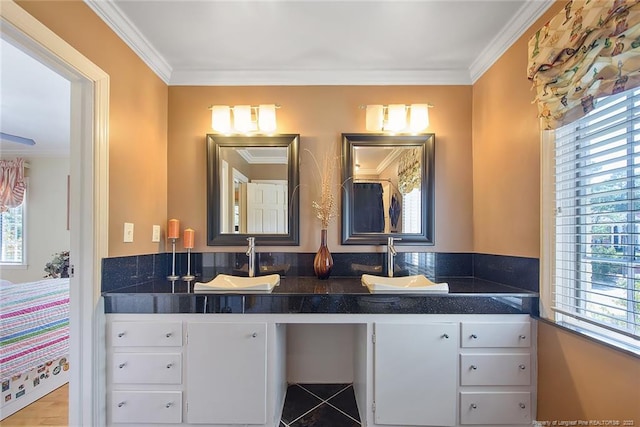 bathroom with a healthy amount of sunlight, dual bowl vanity, and crown molding