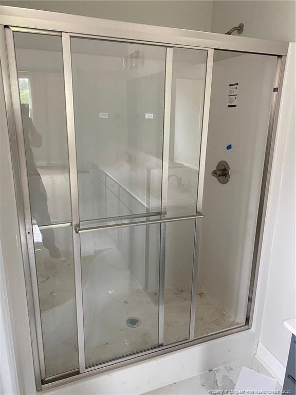 bathroom with a shower with shower door