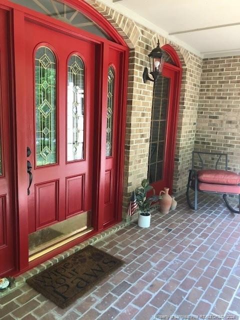 doorway to property with covered porch