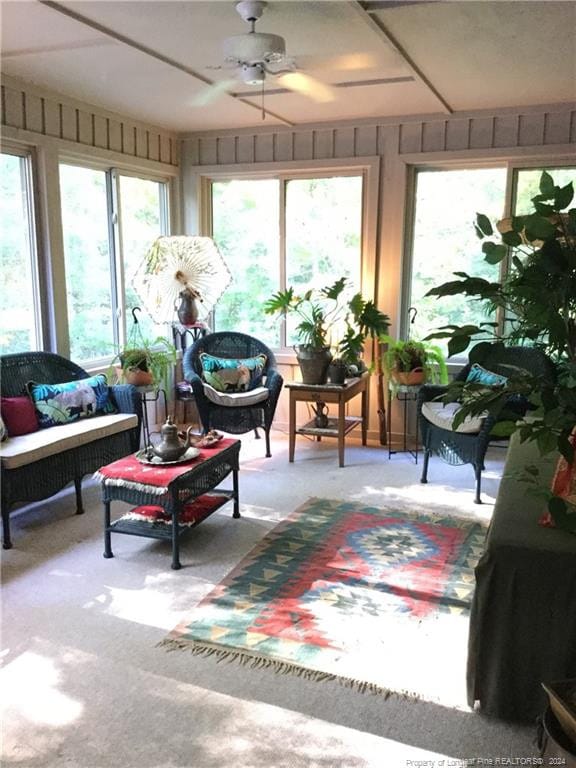 sunroom / solarium with a wealth of natural light and carpet