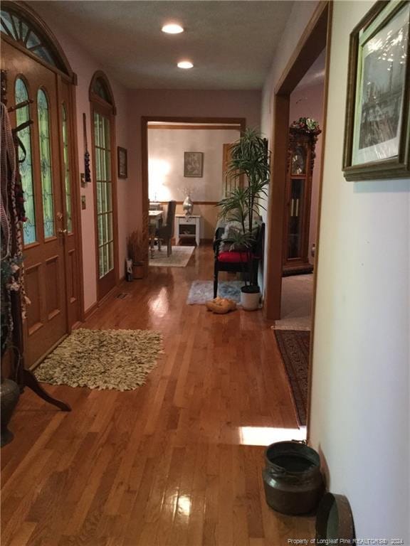 hallway with recessed lighting and wood finished floors