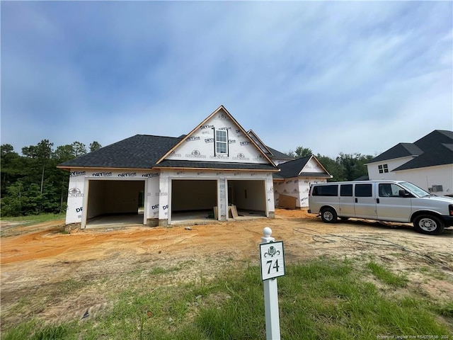 unfinished property featuring a garage