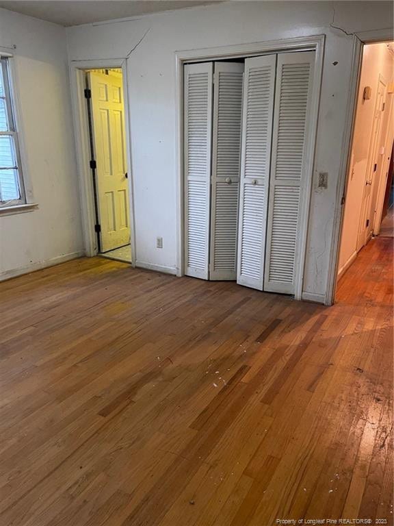 unfurnished bedroom with wood-type flooring