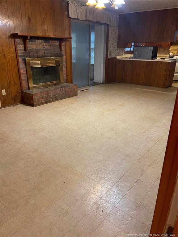 unfurnished living room featuring light tile flooring and a fireplace