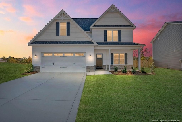 view of front of house with a yard and a garage