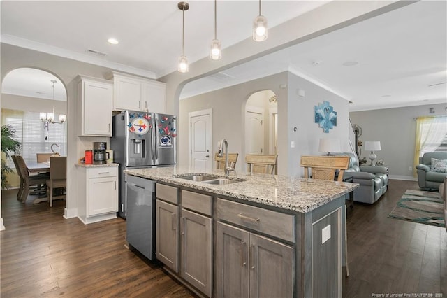 kitchen featuring appliances with stainless steel finishes, dark hardwood / wood-style flooring, sink, a center island with sink, and white cabinets