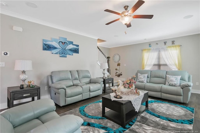 living room featuring dark hardwood / wood-style flooring, ceiling fan, and crown molding