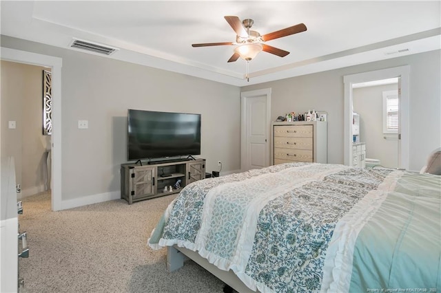 bedroom with light carpet, ceiling fan, and ensuite bathroom