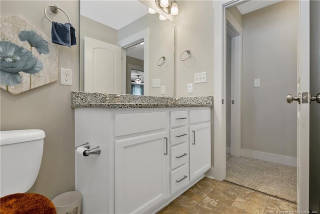 bathroom with toilet, tile flooring, and vanity