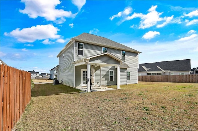 rear view of property featuring a patio and a lawn