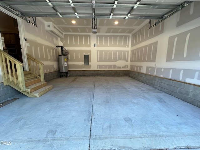 garage featuring electric panel and water heater