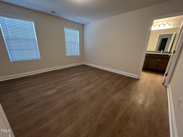 spare room featuring dark hardwood / wood-style flooring and sink