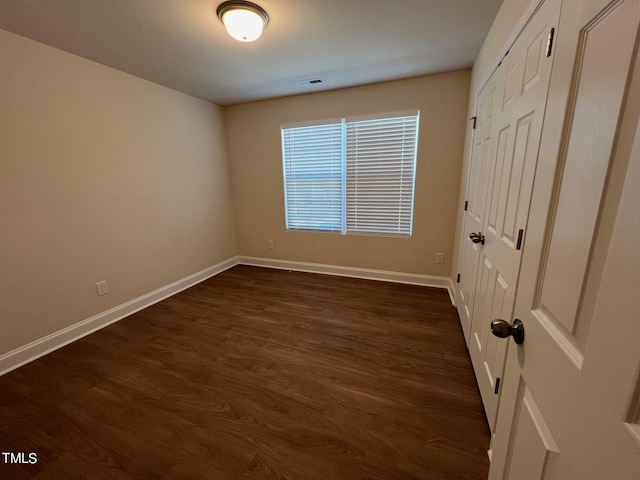 spare room with dark hardwood / wood-style flooring