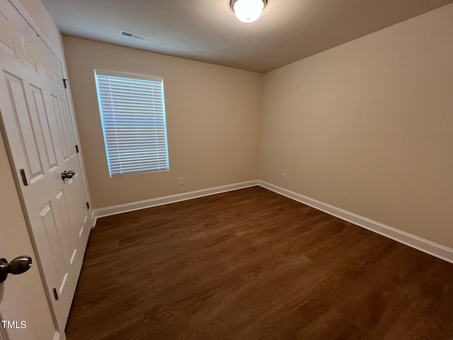 unfurnished room featuring dark hardwood / wood-style floors