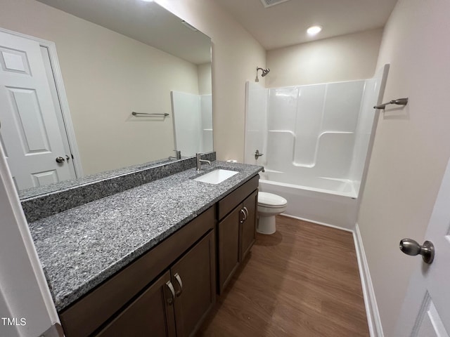 full bathroom with vanity,  shower combination, toilet, and wood-type flooring