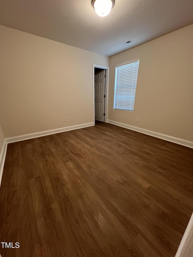 empty room featuring dark hardwood / wood-style flooring