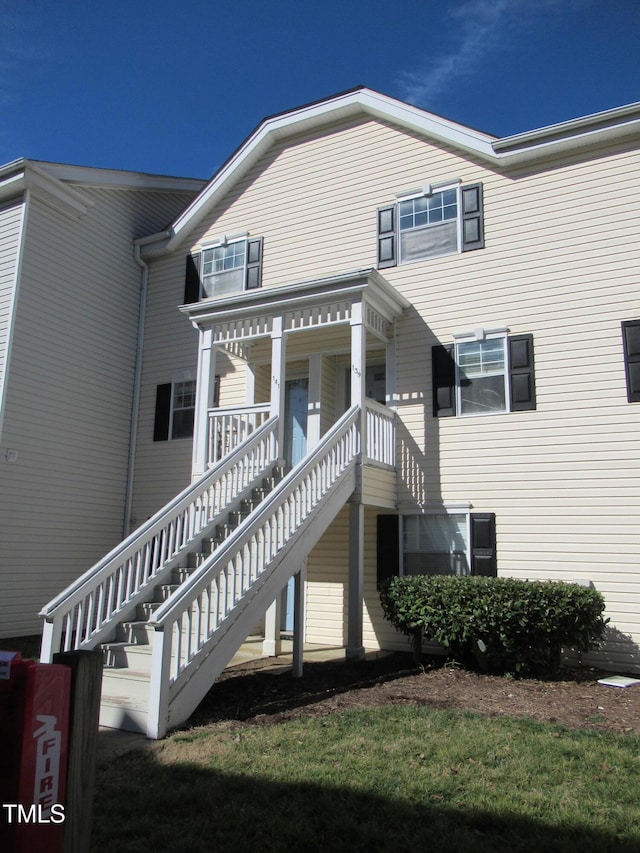 exterior space featuring covered porch and stairway