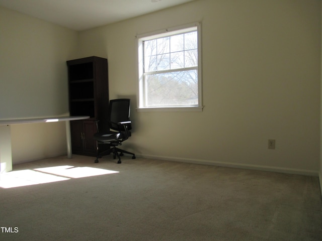 unfurnished office featuring carpet and baseboards