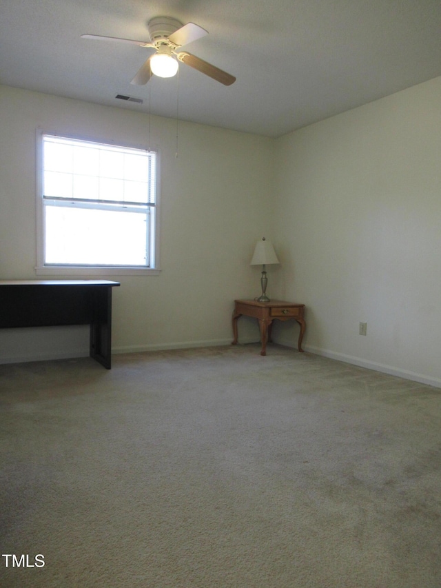 unfurnished room with light carpet, ceiling fan, visible vents, and baseboards