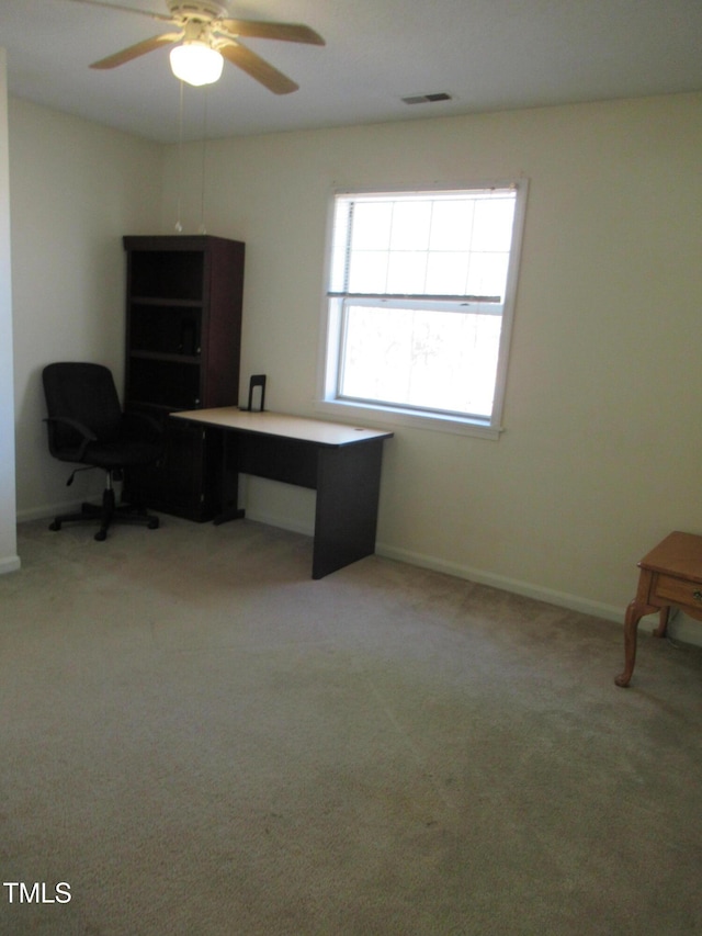 office space featuring a ceiling fan, light carpet, visible vents, and baseboards