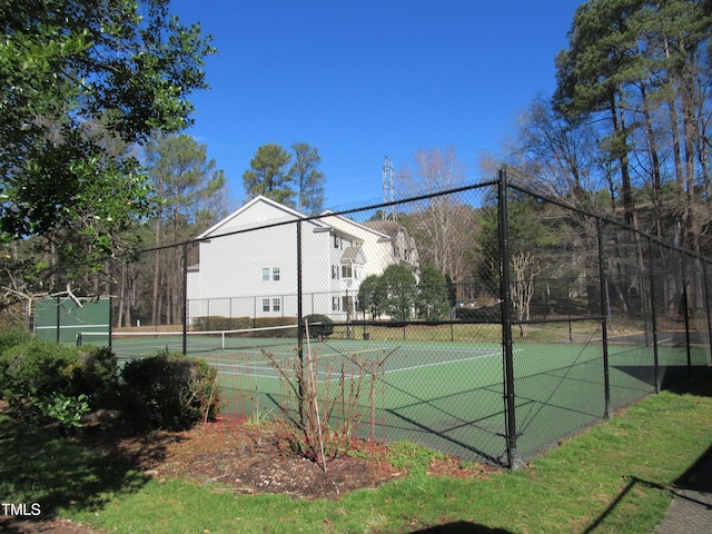 view of tennis court featuring fence