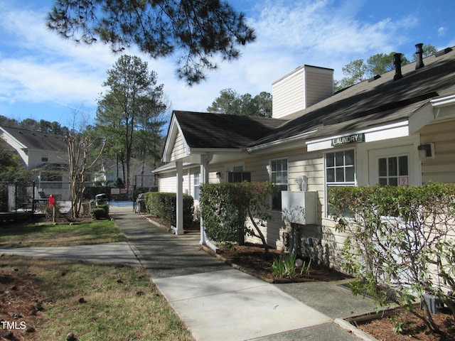 view of side of property featuring a gate and fence