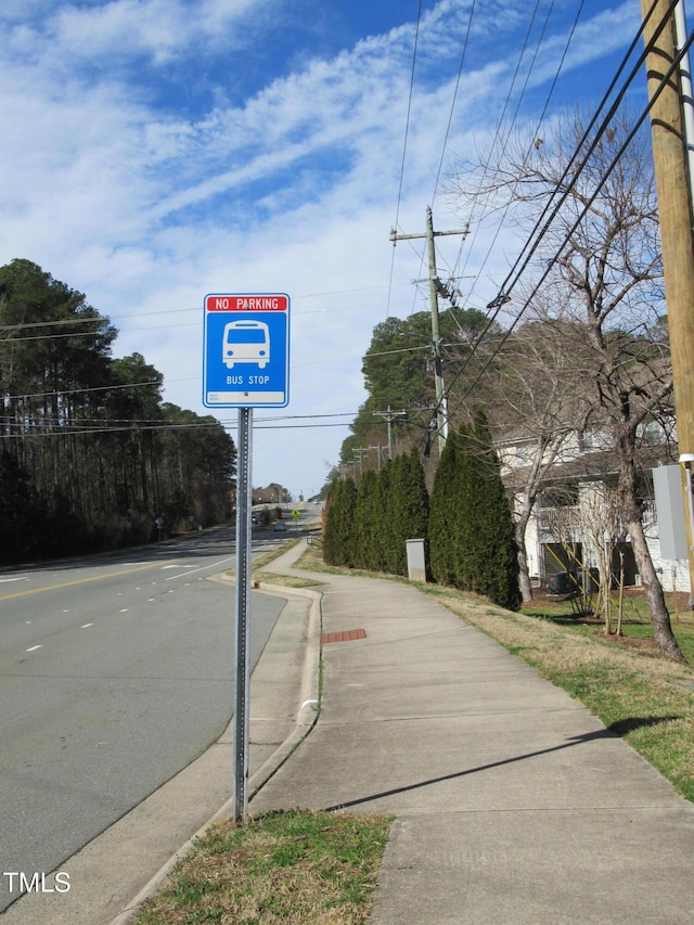 view of road with sidewalks and curbs