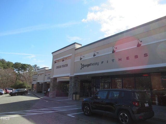 view of building exterior with uncovered parking