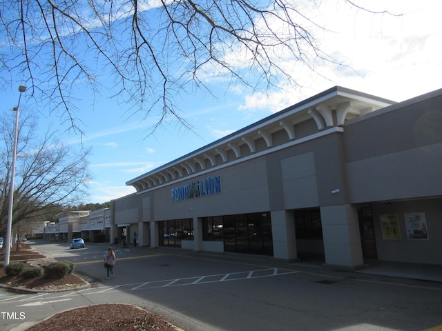 view of property featuring uncovered parking