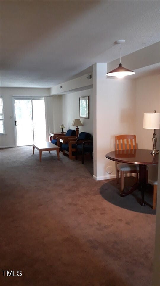 dining area with carpet flooring and baseboards