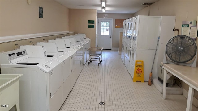 community laundry room featuring stacked washer / dryer, visible vents, and separate washer and dryer