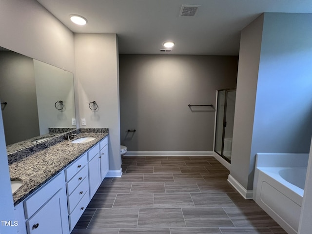 full bathroom with separate shower and tub, vanity, and toilet