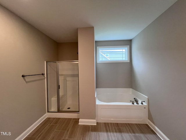 bathroom with shower with separate bathtub and hardwood / wood-style floors