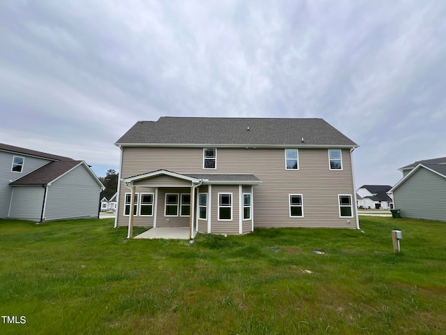 rear view of property with a lawn and a patio area