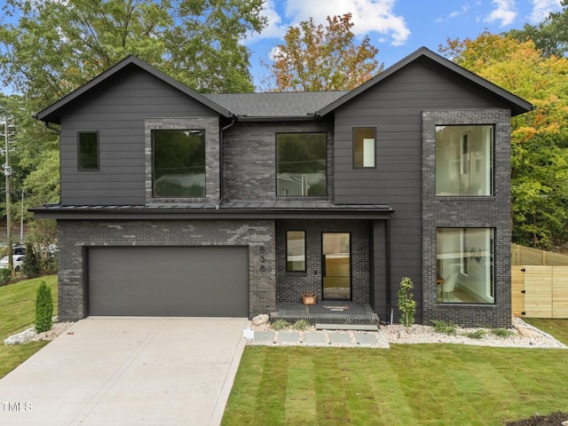 view of front of house featuring a front lawn and a garage