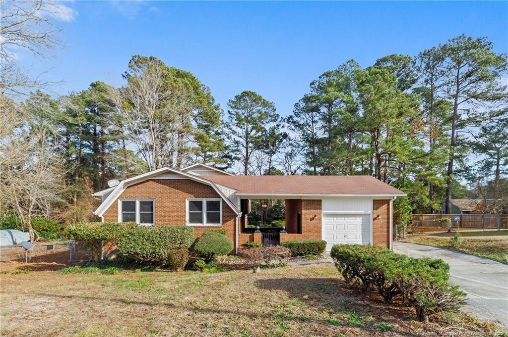 ranch-style home with a front yard and a garage