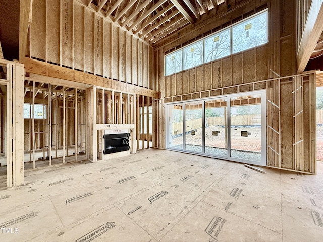 unfurnished living room with a high ceiling