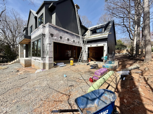 view of home's exterior with a garage, driveway, and a balcony