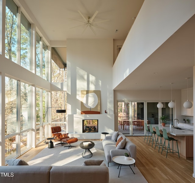 sunroom with sink and a multi sided fireplace